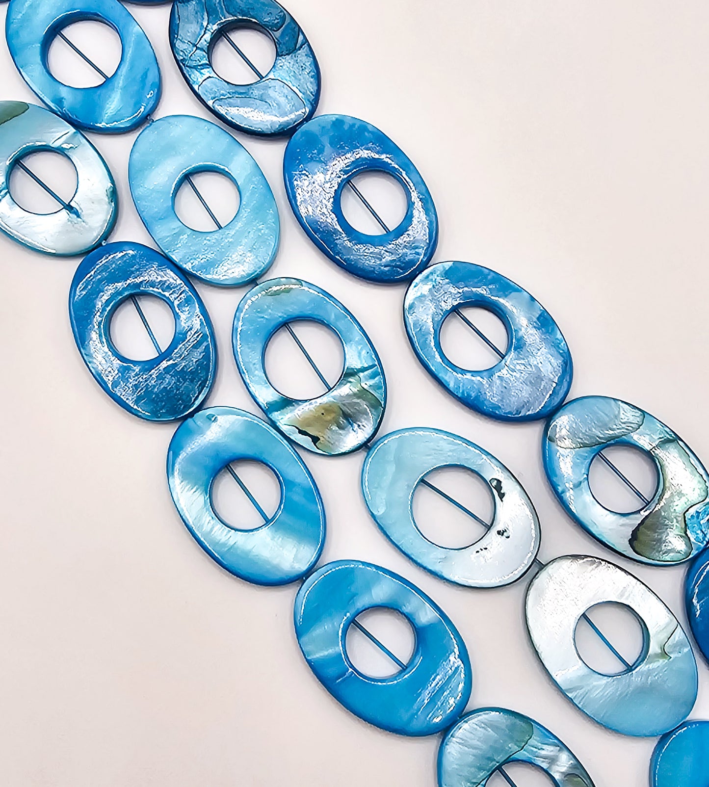 Blue AB Coated Mother of Pearl Oval Beads – Full 16" Strand